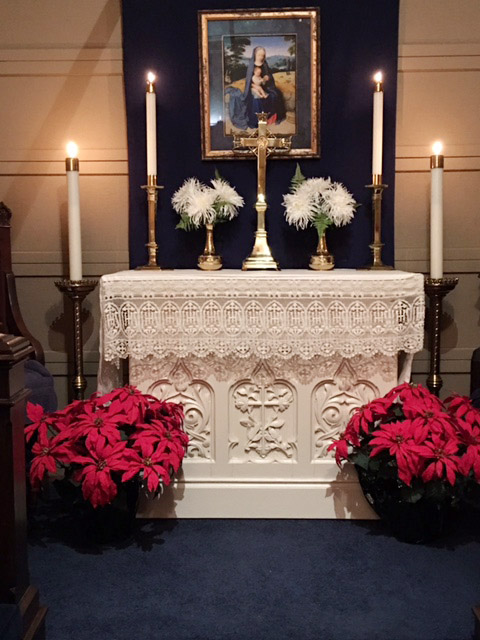 Chapel altar with cross candles and flowers