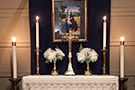 Chapel altar with cross candles and flowers