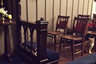 Chapel seating and a cat