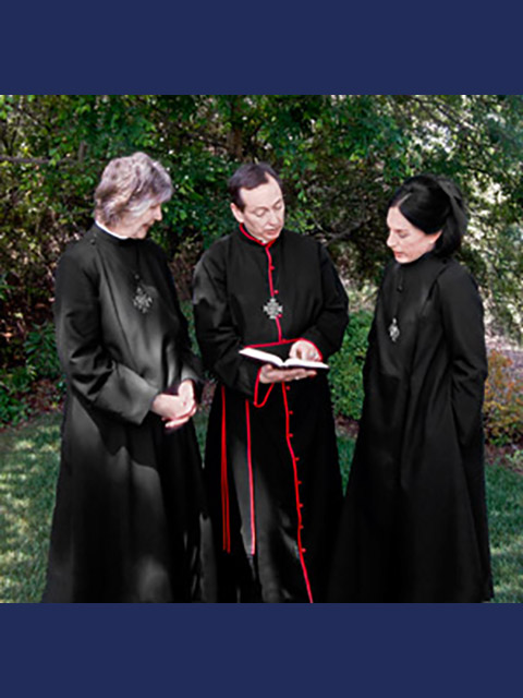 Two women and a man wearing robes and crosses and discussing the Bible