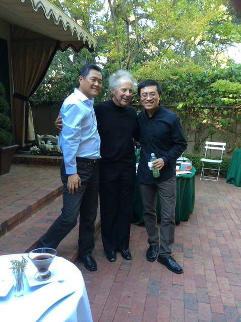 Group of three men standing in a courtyard