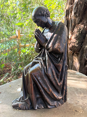 Statue of a monk praying